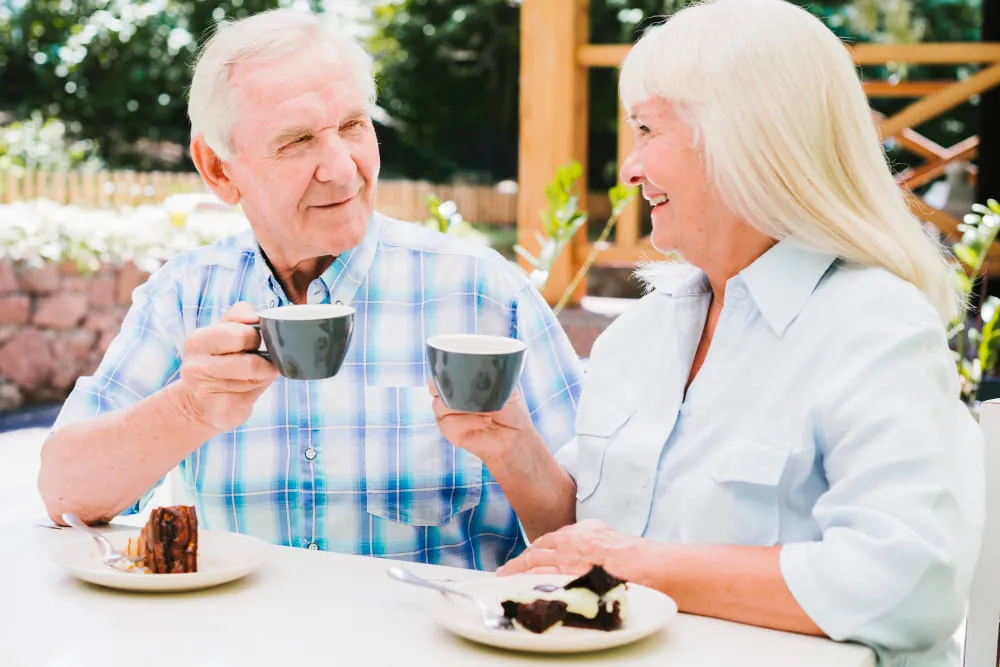 Mature couple talking over coffee outdoors